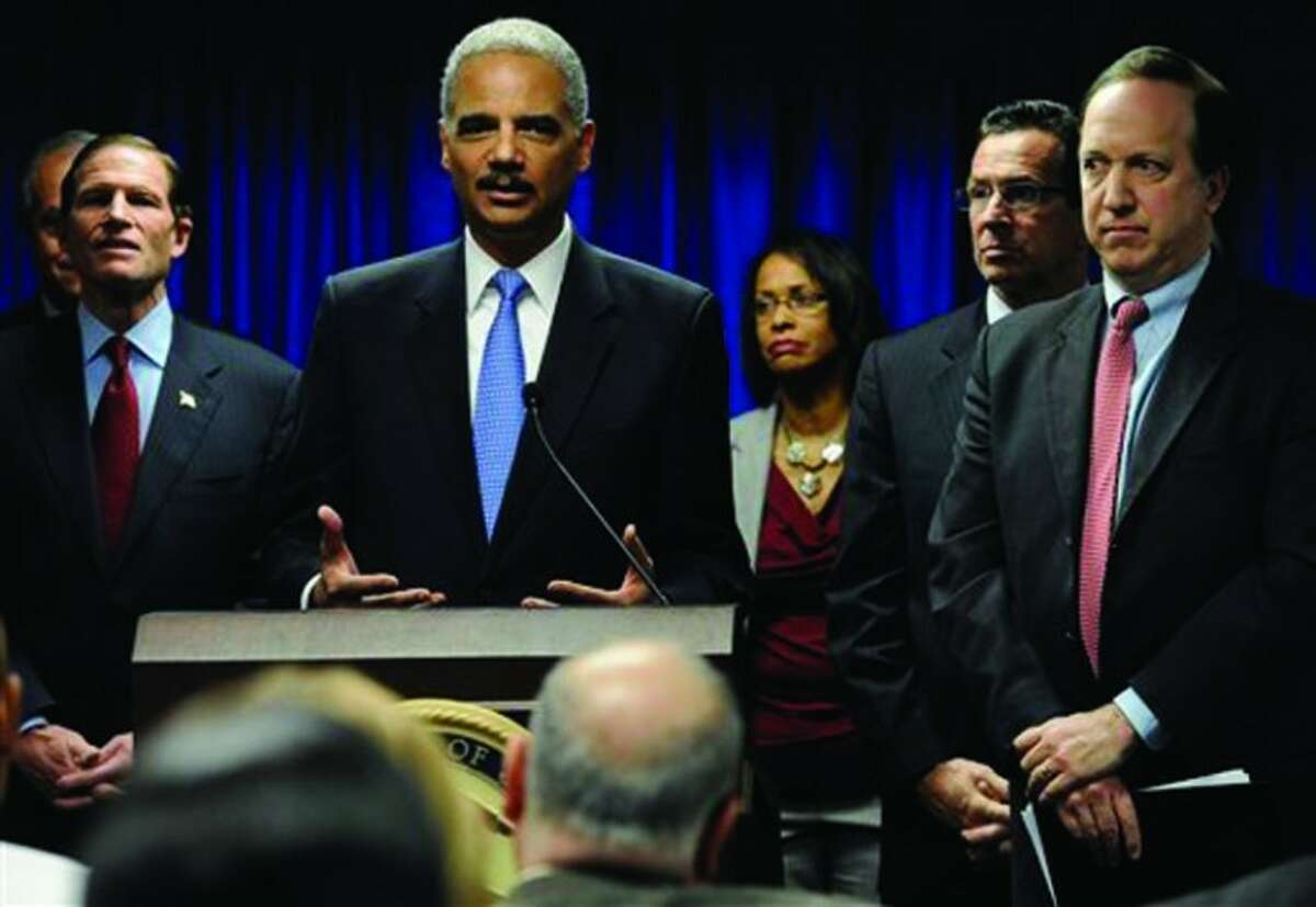 U.S. Attorney General Eric Holder speaks at a news conference to announce a new effort to reduce gun violence in the state's major cities in New Haven, Conn., Tuesday, Nov. 27, 2012. The nation’s top prosecutor and other officials have announced a new effort to reduce gun violence in the Connecticut major cities by directly engaging violent groups. (AP Photo/Jessica Hill)