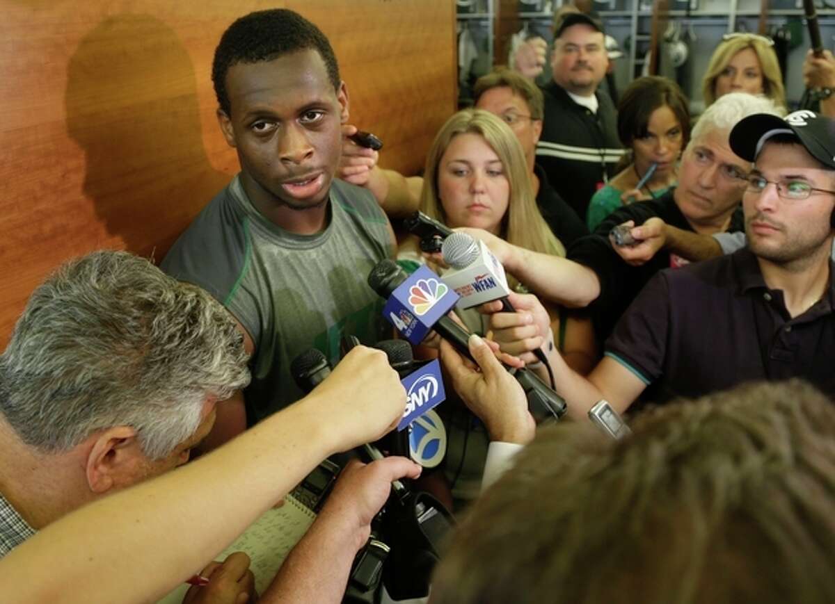 New York Jets quarterback Geno Smith talks to reporters after an NFL football practice in Florham Park, N.J., Monday, Aug. 19, 2013. (AP Photo/Seth Wenig)