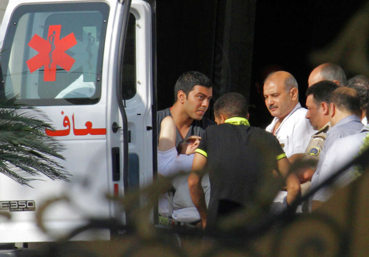 Medics escort former Egyptian President Hosni Mubarak, 85, into an ambulance after after he was flown by a helicopter ambulance to the Maadi Military Hospital from Tora prison in, Cairo, Thursday, Aug. 22, 2013. Mubarak has been released from jail and taken to military hospital in Cairo. (AP Photo/Amr Nabil)