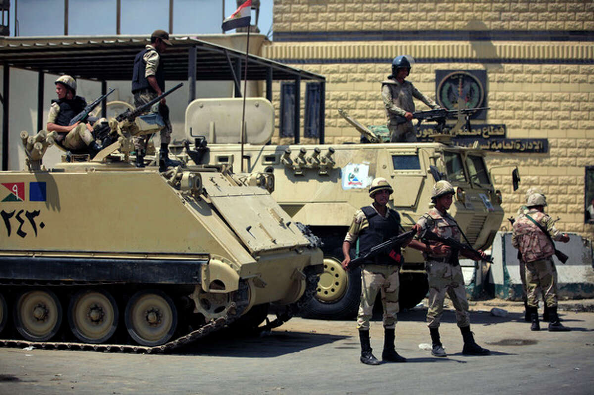 Egyptian army soldiers guard Tora prison, where Egypt's deposed autocrat Hosni Mubarak is held, in Cairo, Thursday, Aug. 22, 2013. A medically equipped helicopter landed Thursday at an Egyptian prison Thursday to transport Mubarak from prison to his new home under house arrest, state TV reported, as dozens of the ousted leader?’s supporters rallied outside waiting for the ousted leader to be released after more than two years in detention. (AP Photo/Khalil Hamra)