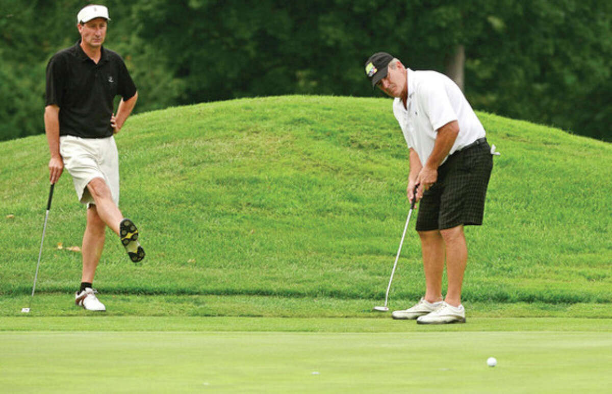 Shorehaven members James Romaniello and Peter Grant on the first hole of the second round during the 17th annual Jerry Courville Tournament at Shorehaven Golf Course Tuesday. Hour photo / Erik Trautmann