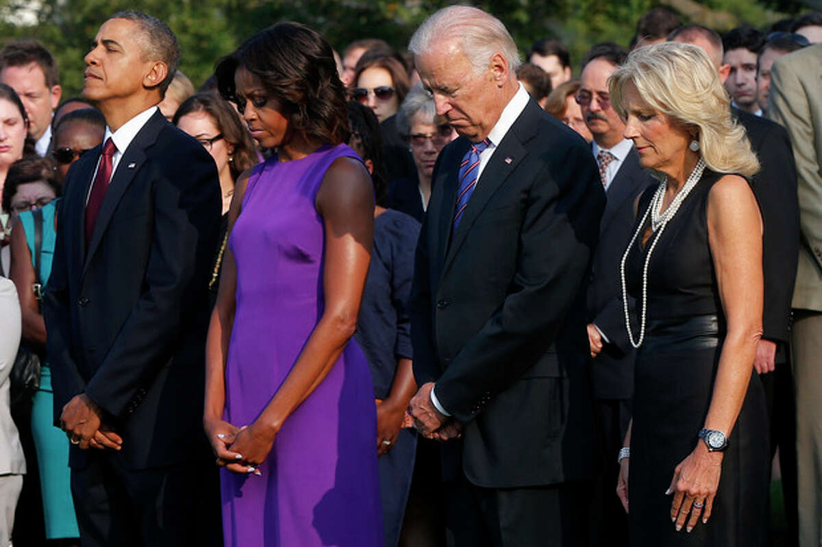 President Barack Obama, first lady Michelle Obama, Vice President Joe Biden, and Jill Biden stand for a moment of silence on the South Lawn of the White House in Washington, Wednesday, Sept. 11, 2013, to mark the 12th anniversary of the September 11 terror attacks. (AP Photo/Charles Dharapak)