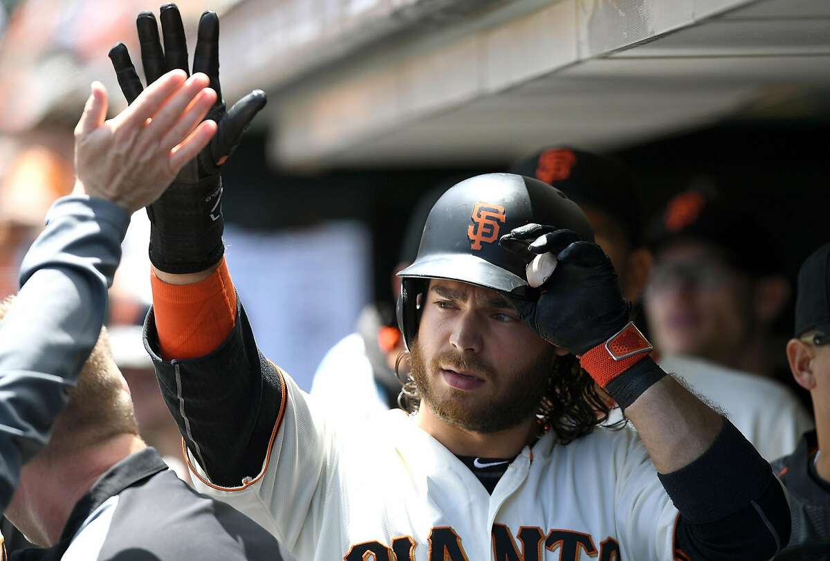 SAN FRANCISCO, CA - JUNE 15: Brandon Crawford #35 of the San Francisco Giants is congratulated by teammates after he scored against the Milwaukee Brewers in the bottom of the third inning at AT&T Park on June 15, 2016 in San Francisco, California. (Photo by Thearon W. Henderson/Getty Images)