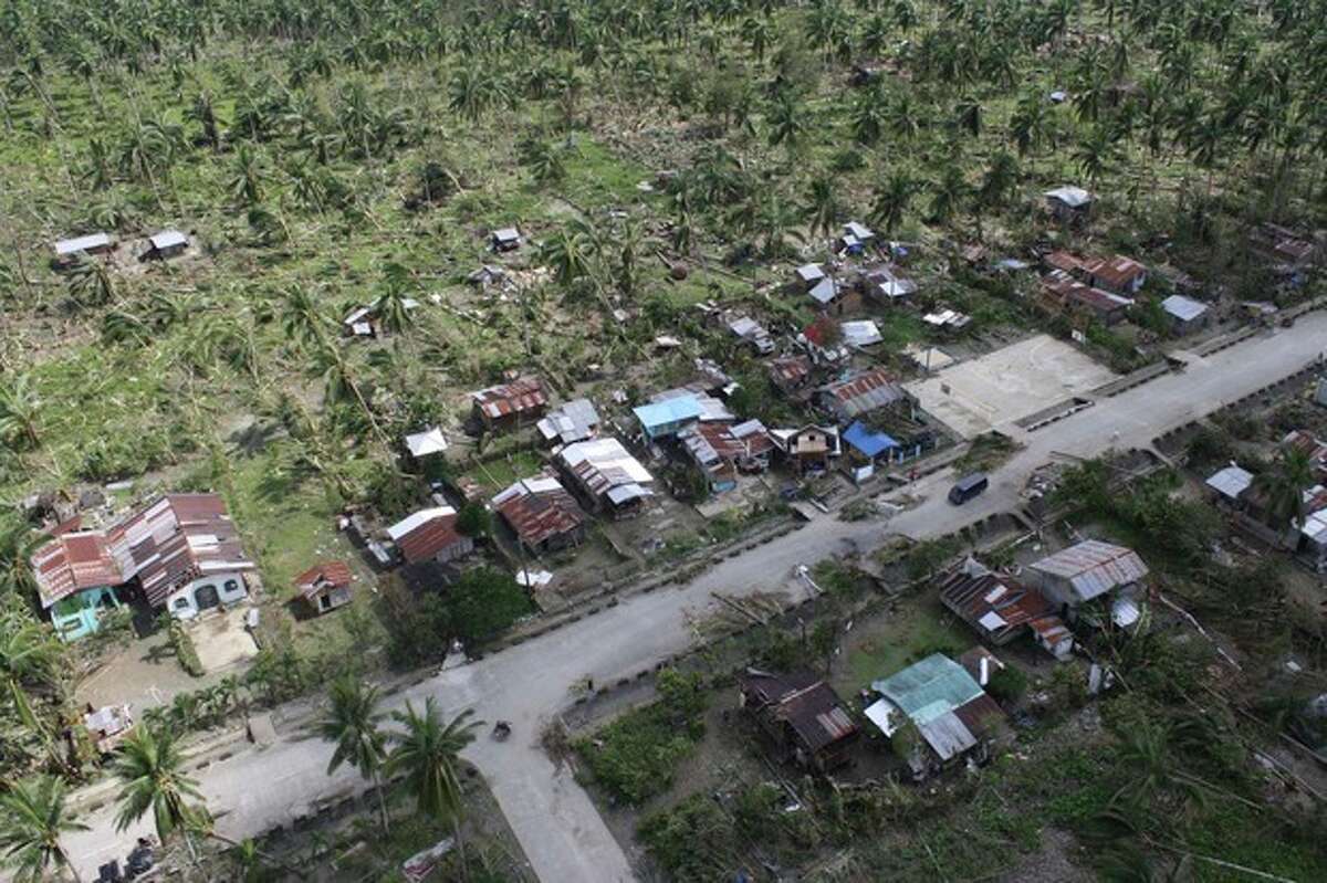 In this photo released by the Philippine Army 10th Infantry Division shows an aerial view of toppled trees and homes caused by flashfloods in Compostela Valley province, southern Philippines on Thursday Dec. 6, 2012. The powerful typhoon that washed away emergency shelters, a military camp and possibly entire families in the southern Philippines has killed hundreds of people with nearly 400 missing, authorities said Thursday. (AP Photo/ Philippine Army 10th ID)