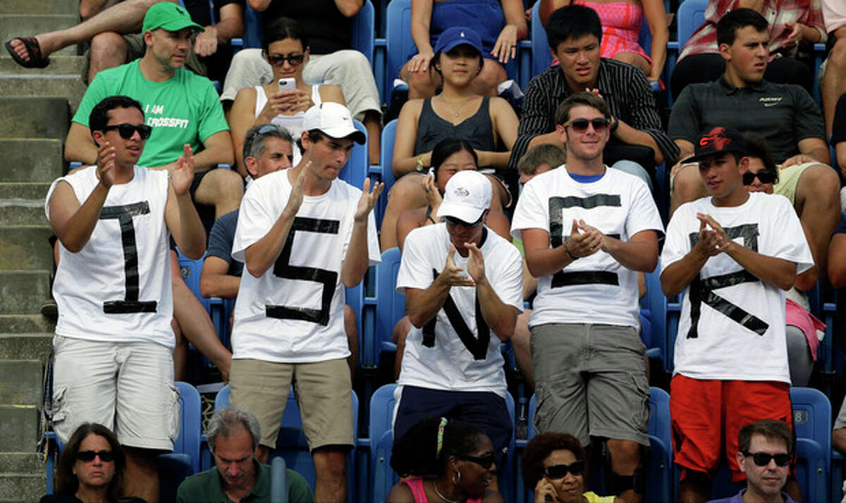 Fans cheer for John Isner during a third round match against Philipp Kohlschreiber, of Germany, at the 2013 U.S. Open tennis tournament, Saturday, Aug. 31, 2013, in New York. (AP Photo/David Goldman)