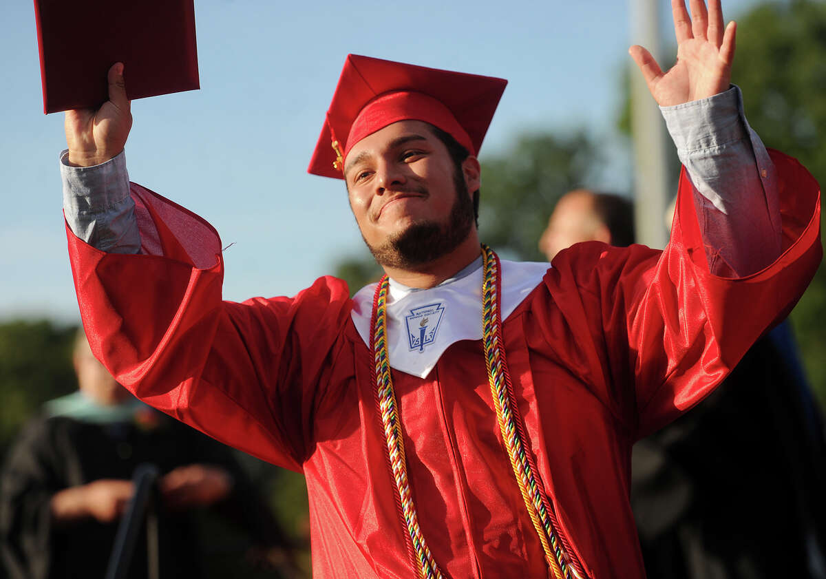 Graduate Elmar Barrios looks to his family after receiving his diploma at the Stratford High School graduation at Penders Field in Stratford, Conn. on Wednesday, June 15, 2016.