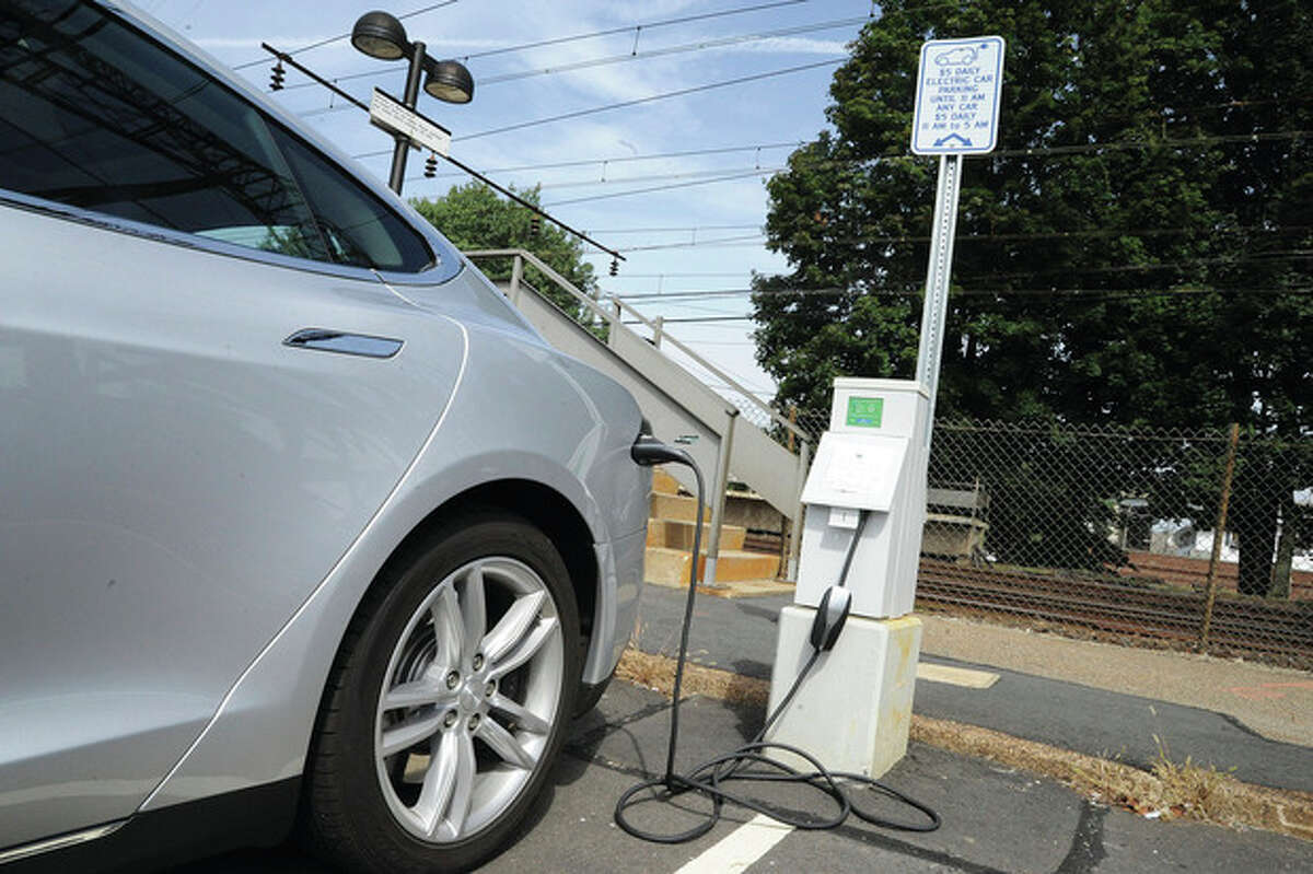 Hour photo/Matthew Vinci A car charges Monday at the new charging station at the Saugatuck Train Station in Westport.