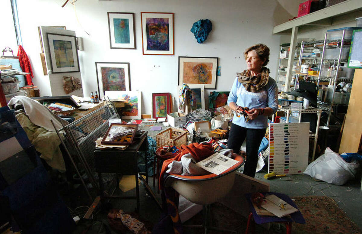Mixed Media Artist Wendi Ohlson stands in her almost 400-square-foot studio in transition in the Loft Artist Association Studios and Gallery in Stamford.