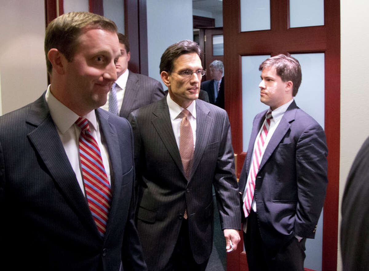 Majority Leader Eric Cantor from Virginia, center, departs after a House Republicans meeting on Capitol Hill, Thursday, Dec. 20, 2012 in Washington. Confronted with a revolt among the rank and file, House Republicans abruptly put off a vote Thursday night on legislation allowing tax rates to rise for households earning $1 million and up.(AP Photo/Alex Brandon)