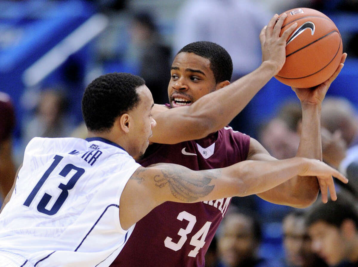 Fordham's Jermaine Myers, right, is guarded by Connecticut's Shabazz Napier during the first half of an NCAA college basketball game in Hartford, Conn., Friday, Dec. 21, 2012. (AP Photo/Fred Beckham)