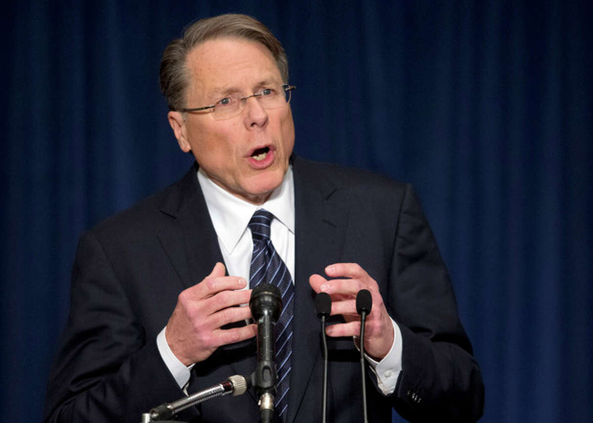 The National Rifle Association executive vice president Wayne LaPierre, gestures during a news conference in response to the Connecticut school shooting on Friday, Dec. 21, 2012 in Washington. The nation's largest gun-rights lobby is calling for armed police officers to be posted in every American school to stop the next killer "waiting in the wings." (AP Photo/ Evan Vucci)