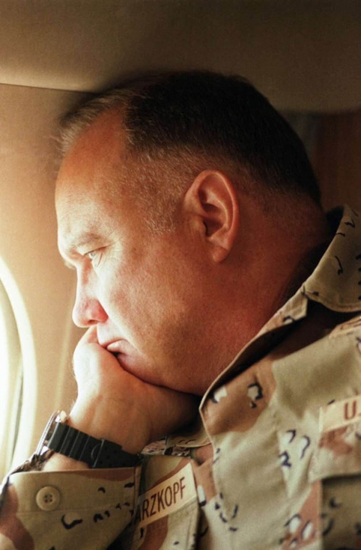 FILE - In this Jan. 13, 1991 file photo, General H. Norman Schwarzkopf, commander of U.S. troops in the Gulf, gazes from the window of his small jet on his way out to visit U.S. troops in the desert in Saudi Arabia. Schwarzkopf died Thursday, Dec. 27, 2012 in Tampa, Fla. He was 78. (AP Photo/Bob Daugherty, File)