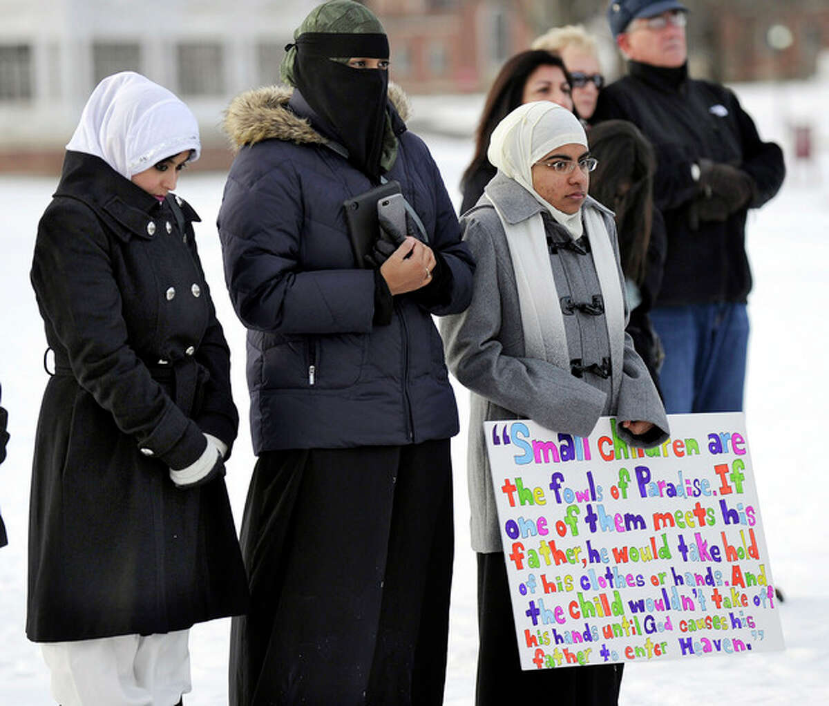 From left, Naveera Karim, Ayesha Akhtar and Anwar Abdulrehman, members of the Islamic Society of Western Connecticut, attend an interfaith prayer vigil to remember the victims of the Sandy Hook elementary school shootings Friday, Dec. 28, 2012 in Newtown, Conn. Friday morning marked two weeks since a gunman killed 20 children and six educators at the Sandy Hook Elementary School. (AP Photo/Danbury News-Times, Carol Kaliff)