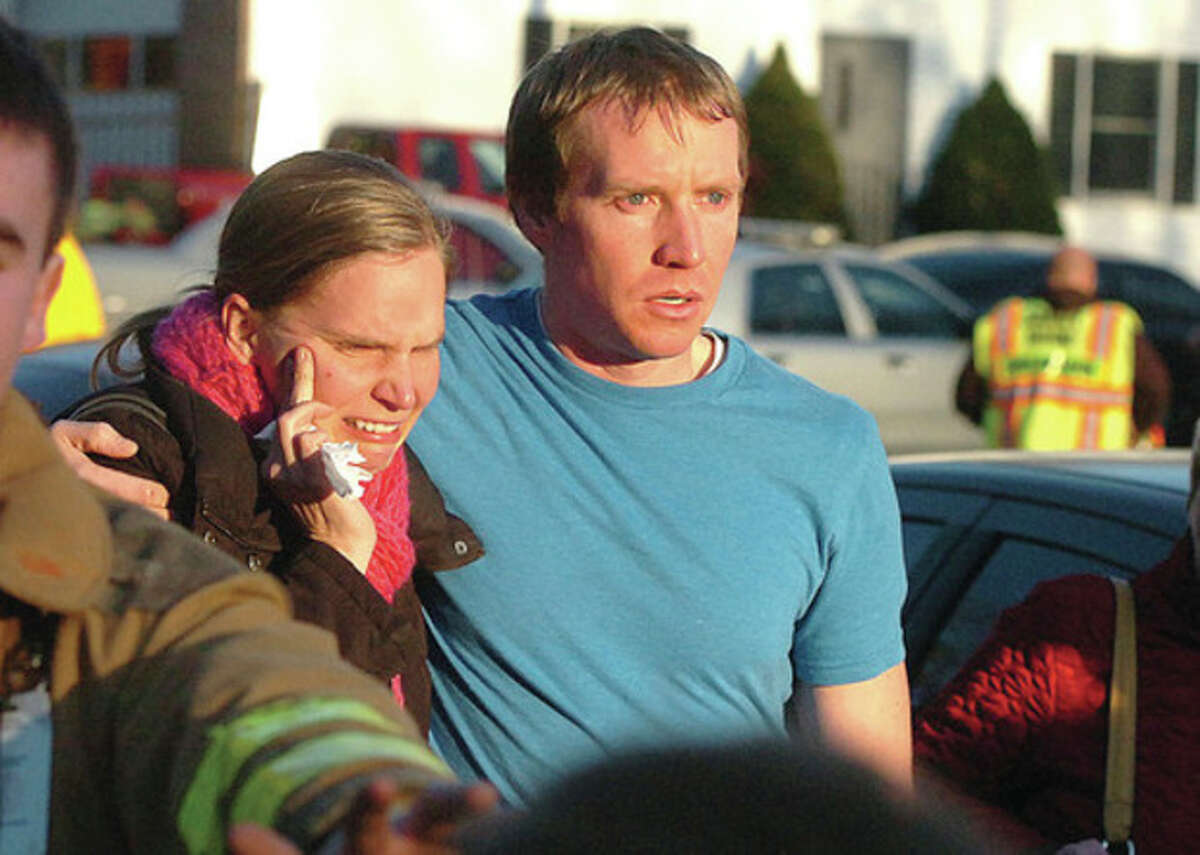Hour Photo/Alex von Kleydorff People leave the Sandy Hook Volunteer Fire House in tears after a shooting massacre at The Sandy Hook School nearby on Friday morning.