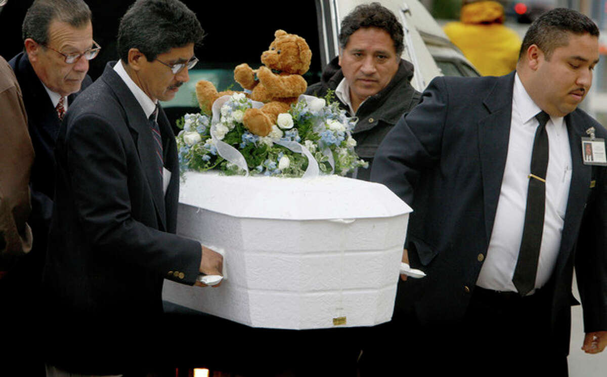FILE - In this Jan. 23, 2009 file photo, pallbearers carry the casket of 4-year-old Roberto Lopez Jr., outside Our Lady of Angels Church in Los Angeles. The boy was shot in the chest a week earlier as he walked with his 5-year-old sister in a gang-plagued Echo Park neighborhood. In the wake of the Dec. 14, 2012 mass shooting at Sandy Hook Elementary School in the small town of Newtown, Conn., there is now much political discussion about gun control. For urban advocates, this new emphasis on gun control is long overdue. (AP Photo/Mark Boster, Pool, File)