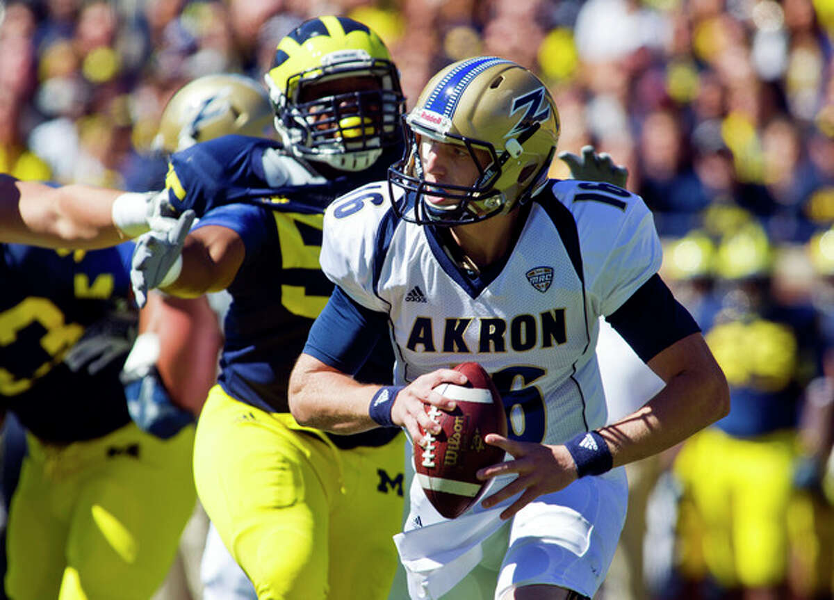 Michigan defensive tackle Jibreel Black (55) pressures Akron quarterback Kyle Pohl (16) in the first quarter of an NCAA college football game, Saturday, Sept. 14, 2013, in Ann Arbor, Mich. (AP Photo/Tony Ding)