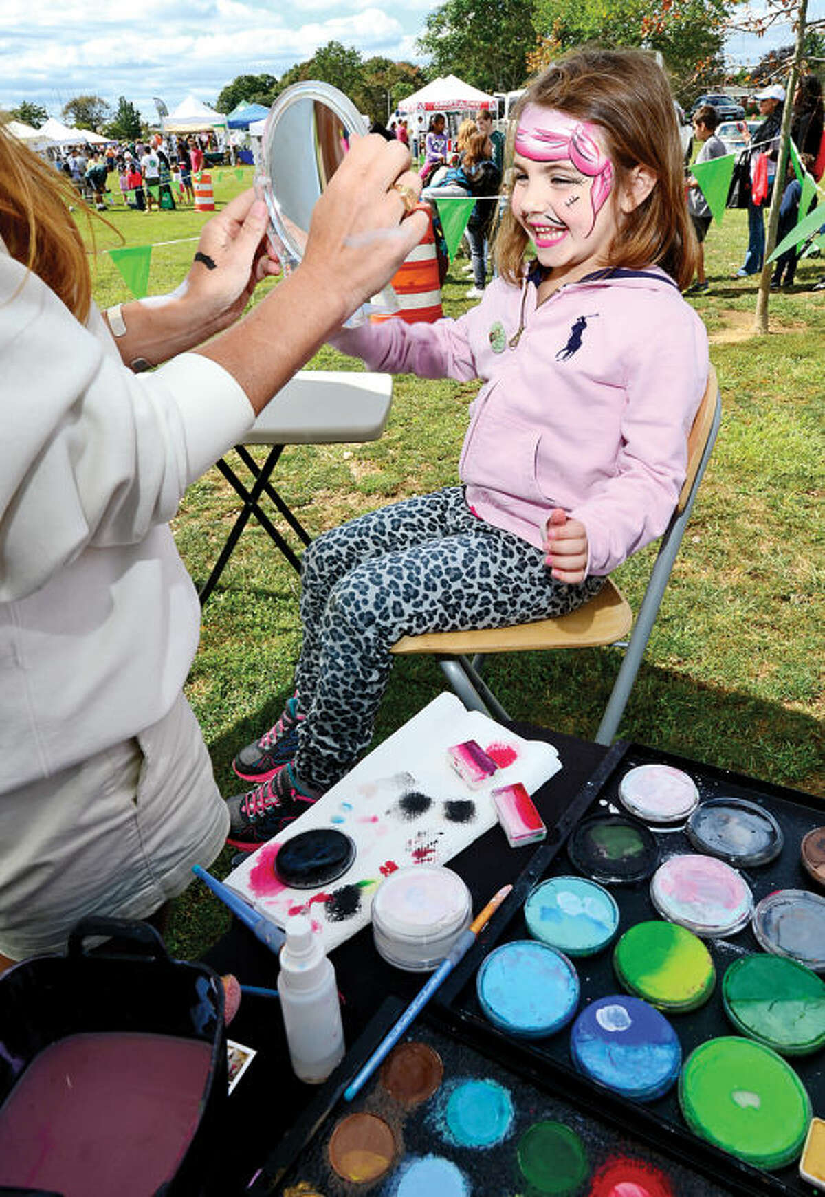 Madison Farrer,5, gets her face painted during the Live Green Connecticut! green-living and family festival Saturday at Taylor Farm Park. The two-day festival promotes living green with a focus on education, sustainability, caring for the environment and our natural resources.Hour photo / Erik Trautmann