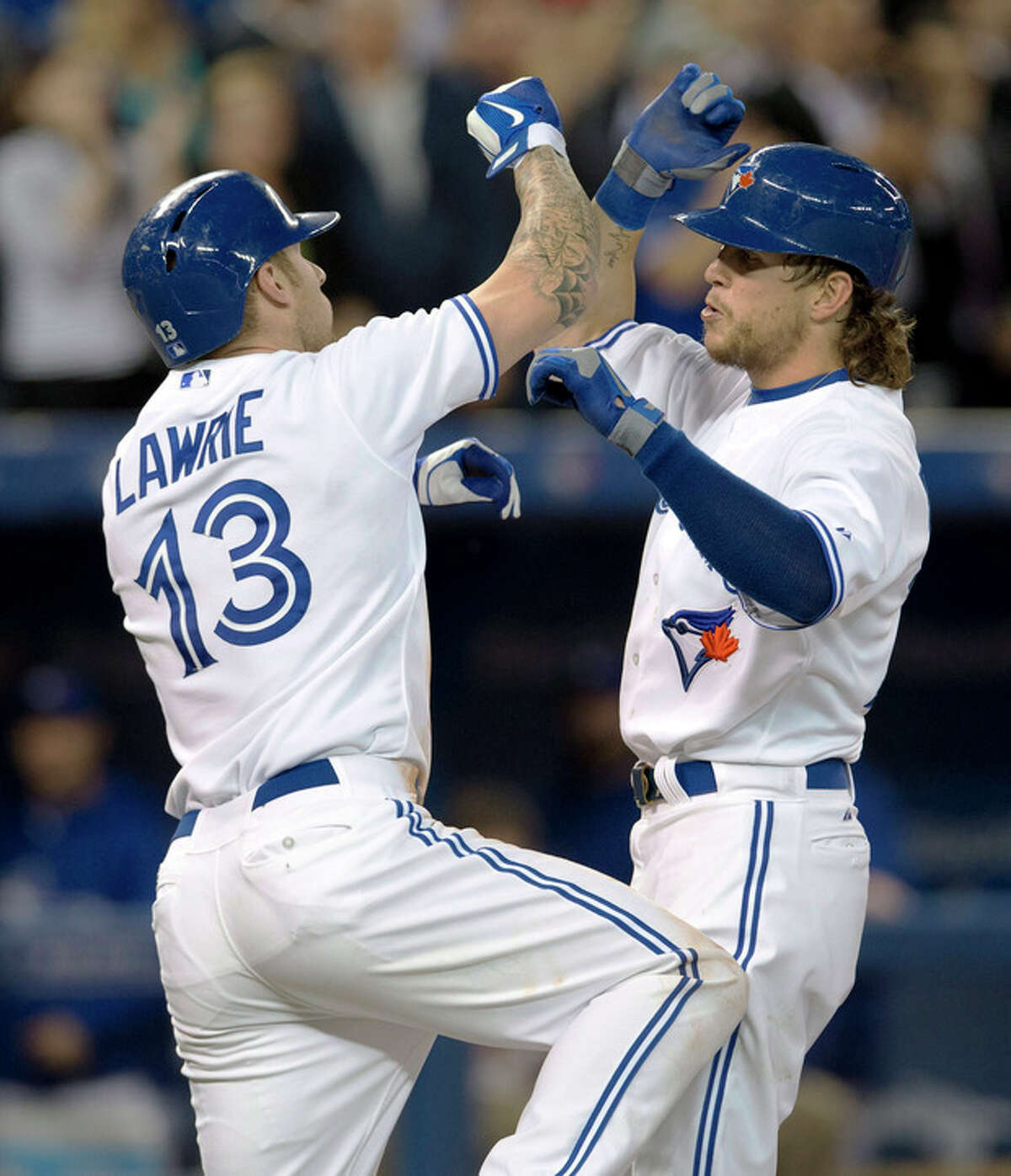 Toronto Blue Jays' Colby Rasmus, right, celebrates his two run home run against the New York Yankees with teammate Brett Lawrie during the fourth inning of MLB American League baseball action in Toronto Wednesday, Sept. 18, 2013. (AP Photo/The Canadian Press, Mark Blinch)