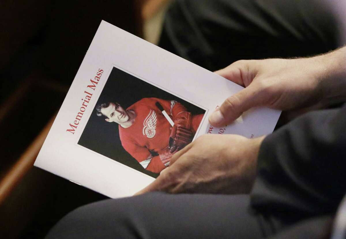 An attendee holds a program for the funeral service of Gordie Howe at the Cathedral of the Most Blessed Sacrament in Detroit.