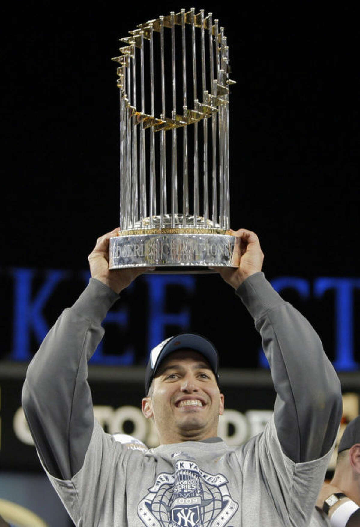 FILE - In this Nov. 4, 2009, file photo, New York Yankees' Andy Pettitte holds up the championship trophy after Game 6 of baseball's World Series against the Philadelphia Phillies in New York. Pettitte is retiring from baseball at the conclusion of the season, the Yankees announced on Friday, Sept. 20, 2013. (AP Photo/Elise Amendola, File)