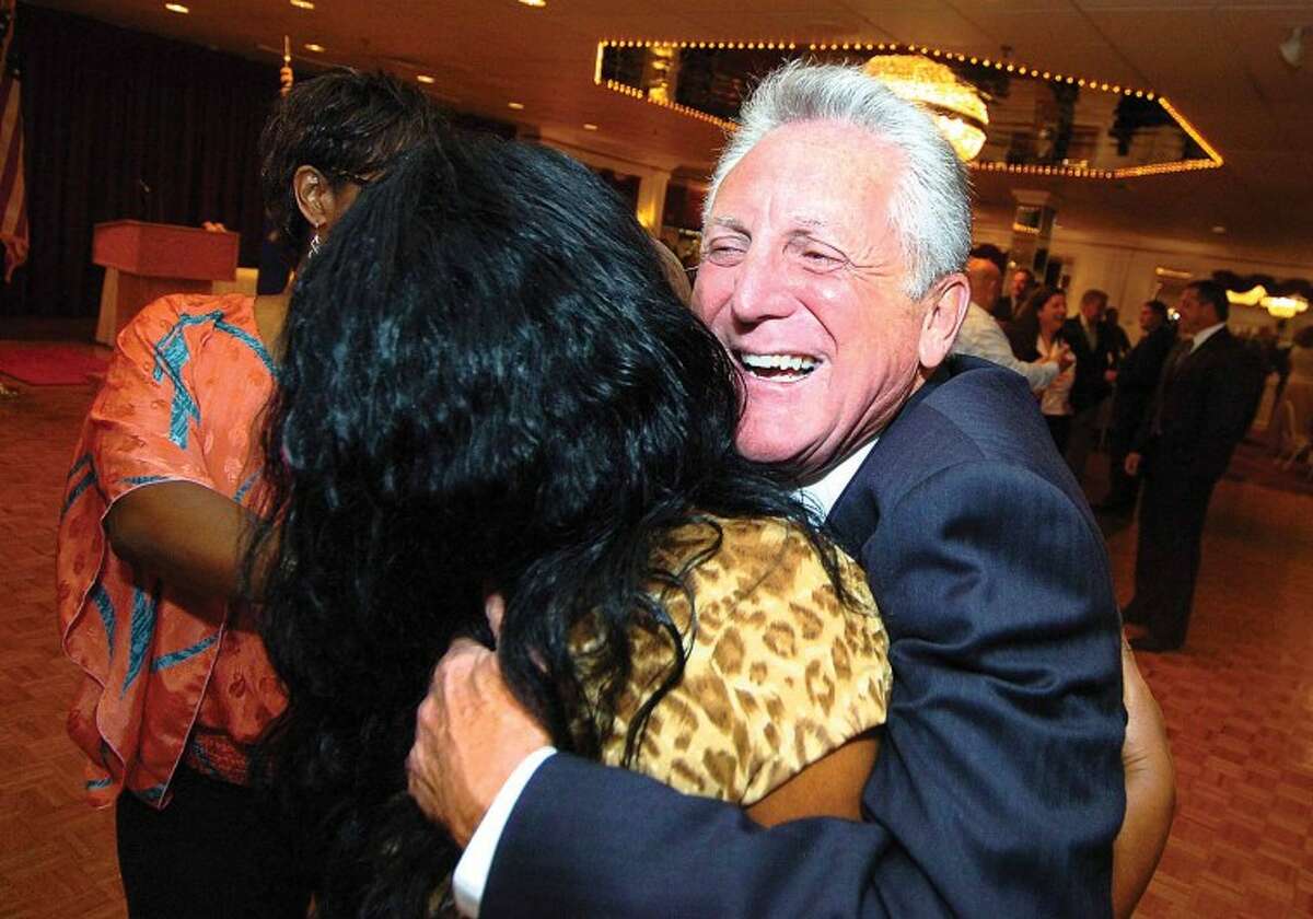 Hour Photo/ Alex von Kleydorff. Harry Rilling gets a big hug from Sally Johnson, Executive assistant for Mayor Moccia during his retirement party at Continental Manor on Thursday night.