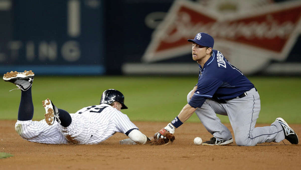 New York Yankees' Mark Reynolds (39) is safe at second on a second-inning sacrifice fly as Tampa Bay Rays second baseman Ben Zobrist loses the ball in a baseball game Wednesday, Sept. 25, 2013, in New York. (AP Photo/Kathy Willens)