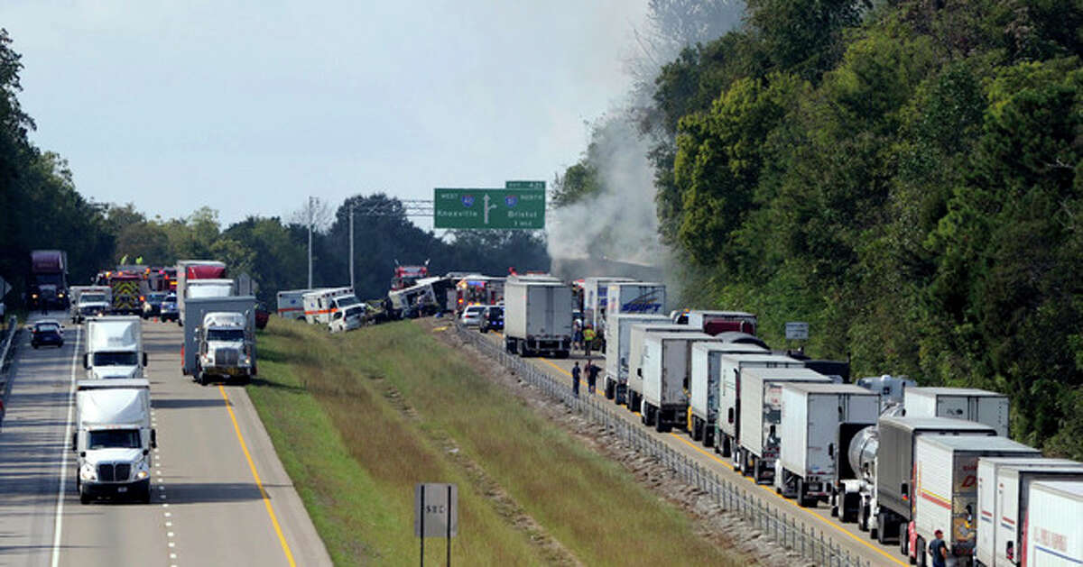 Emergency personnel arrive on the scene near a collision involving a bus on I-40, in Dandridge, Tenn, on Wednesday, Oct. 2, 2013. A spokeswoman for Tennessee's Safety Department says there are multiple fatalities and injuries in an interstate bus crash between a passenger bus, a tractor-trailer and another vehicle. (AP Photo/The Knoxville News Sentinel, Michael Patrick)