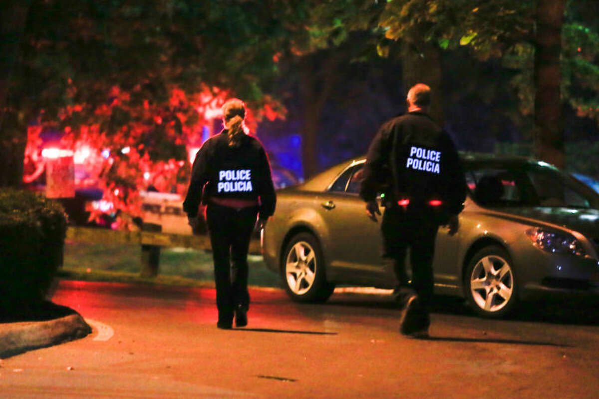 Stamford Police enter the evacuated Woodside Green condominiums thought to be the home of a woman killed by police in Washington, DC Thursday evening. Hour Photo / Chris Palermo