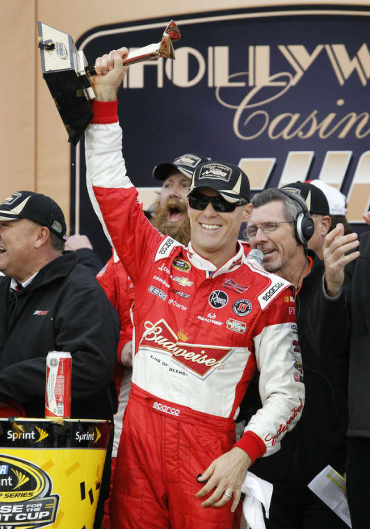 Driver Kevin Harvick celebrates in victory lane after winning the Hollywood Casino 400 NASCAR Sprint Cup series auto race at Kansas Speedway in Kansas City, Kan., Sunday, Oct. 6, 2013. (AP Photo/Colin E. Braley)