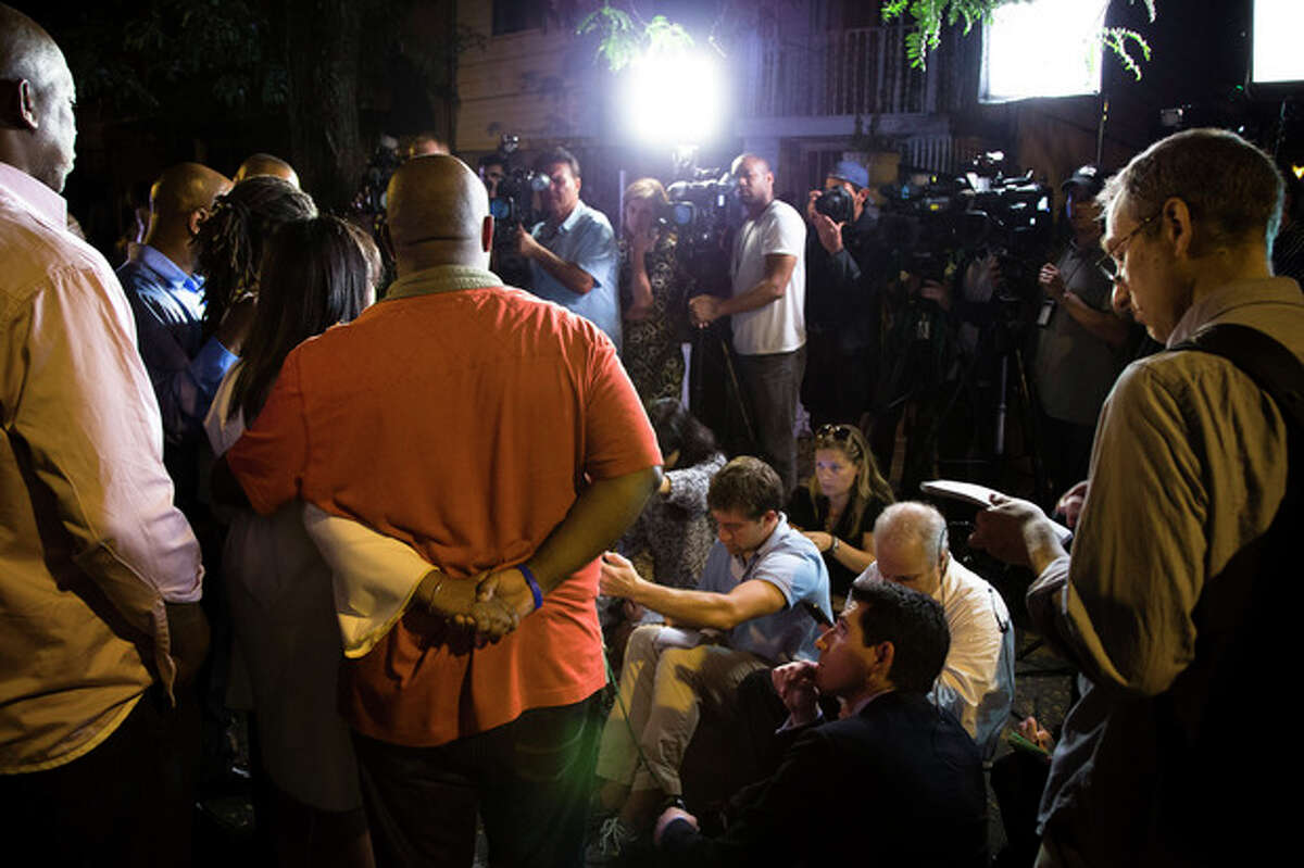 Valarie Carey, sister of Mariam Carey, and her husband hold hands as they speak to the media outside her home in the Bedford-Stuyvesant neighborhood of Brooklyn, Friday, Oct. 4, 2013, in New York. Law-enforcement authorities have identified Miriam Carey, 34, as the woman who, with a 1-year-old child in her car, led Secret Service and police on a harrowing chase in Washington from the White House past the Capitol Thursday, attempting to penetrate the security barriers at both national landmarks before she was shot to death, police said. The child survived. (AP Photo/John Minchillo)