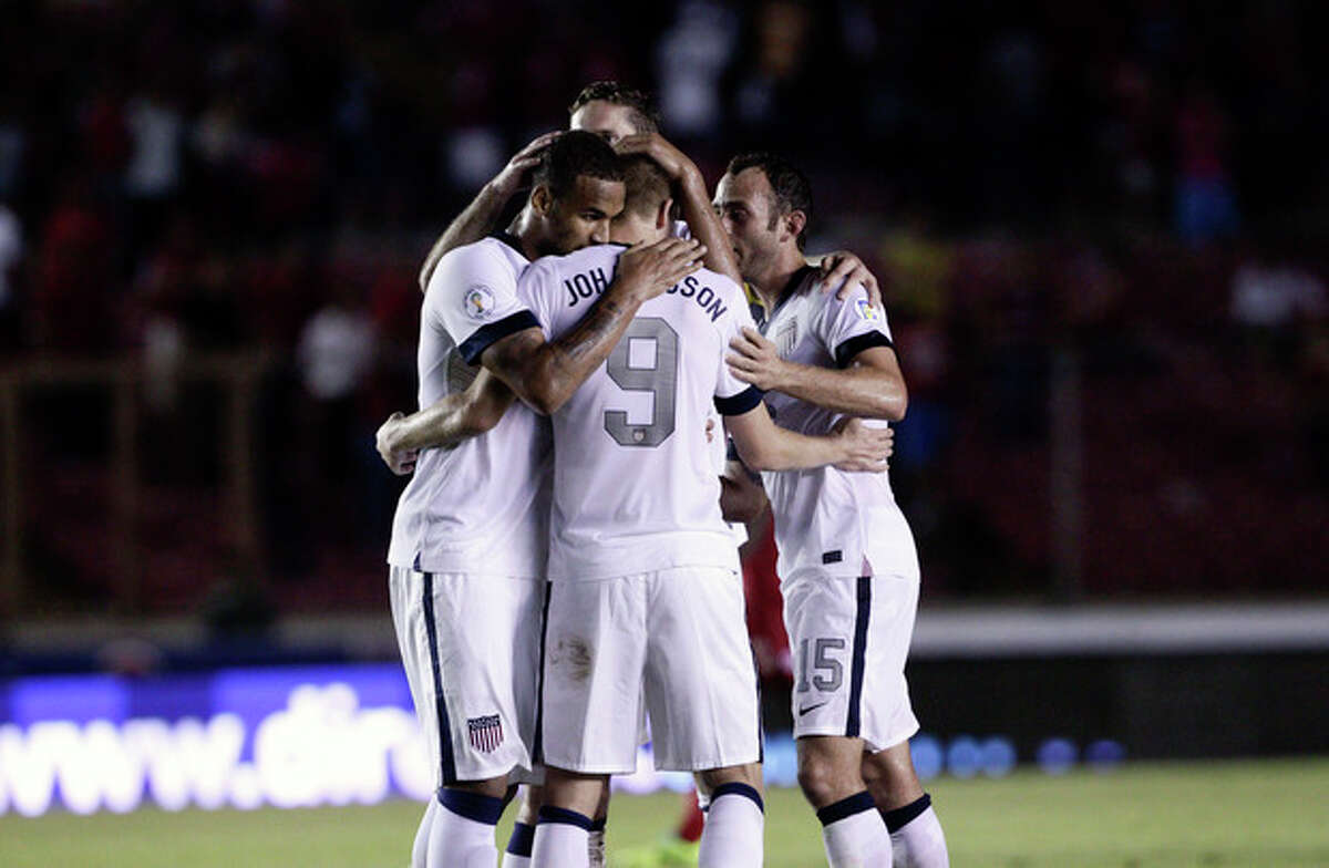 Aron Johannsson, center, of the U.S. celebrates with teammates after scoring a goal against Panama in a 2014 World Cup qualifying soccer match, in Panama City, Tuesday, Oct. 15, 2013. The United States rallied for a 3-2 win at Panama on Tuesday night that left Mexico's World Cup hopes alive and knocked out the Panamanians. (AP Photo/Arnulfo Franco)