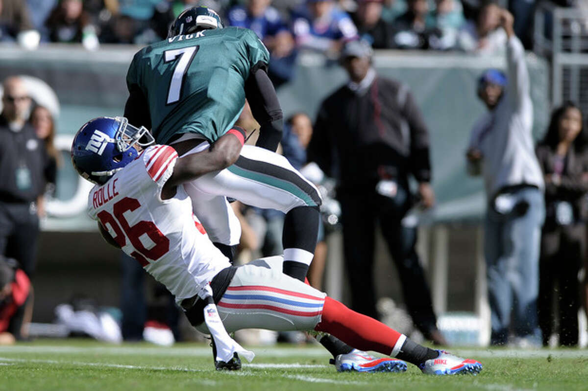 New York Giants strong safety Antrel Rolle (26) sacks Philadelphia Eagles quarterback Michael Vick (7) during the first half of an NFL football game on Sunday, Oct. 27, 2013, in Philadelphia. (AP Photo/Michael Perez)