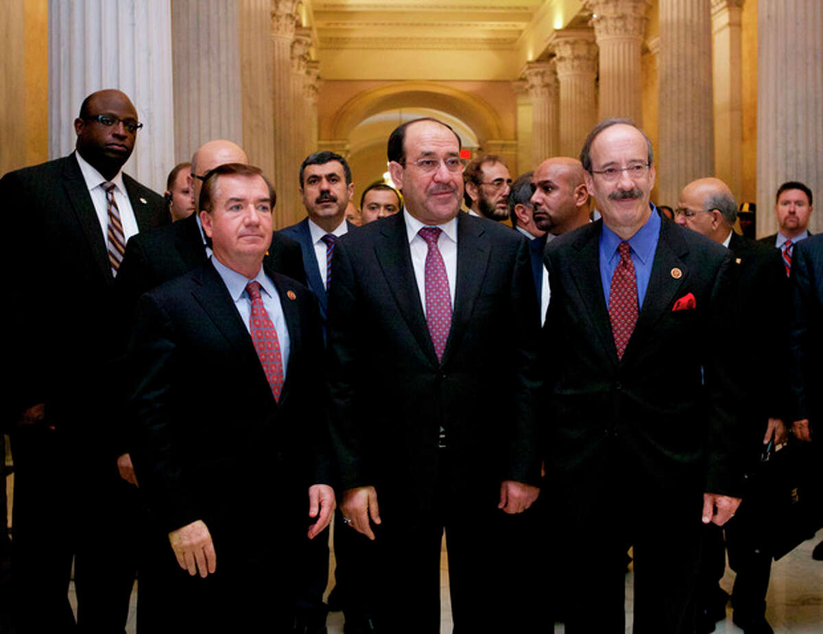 Iraq's Prime Minister Nouri al-Maliki, center, walks with Rep. Eliot Engel, D-N.Y., right, and Rep. Ed Royce, R-Calif., on Capitol Hill in Washington, Wednesday, Oct. 30, 2013, before their meeting. Earlier, the prime minister met with Vice President Joe Biden. (AP Photo/Molly Riley)