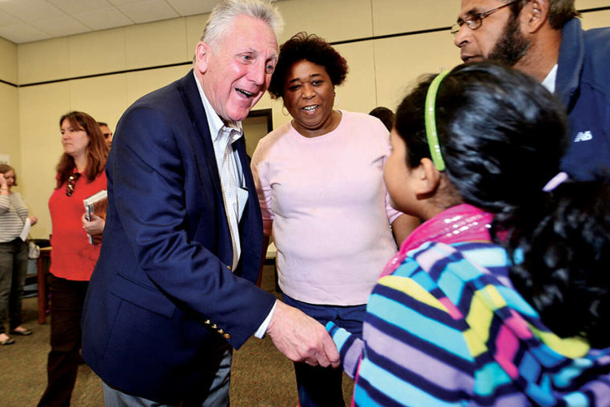 Hour photo / Erik Trautmann Mayoral candidate Harry Rilling talks with 8 year old Salwa Sarwer while volunteer and Norwalk Reads! board member Corrine Weston looks on as Rilling campaigns at their event at the Norwalk Public Library on Belden Ave Saturday.