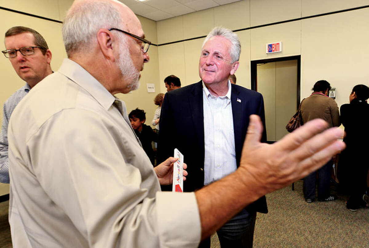 Hour photo / Erik Trautmann Mayoral candidate Harry Rilling talks with chairman of Norwalk Reads! Stephen Bentkover as Rilling campaigns at their event at the Norwalk Public Library on Belden Ave Saturday.