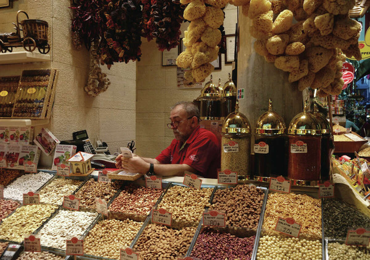 AP Photo A man sits in his shop in the 17th century Spice Market, or the Egyptian Bazaar, with stalls beautifully displaying spices, dried fruit, nuts, apple tea, essential oils, and "Turkish Delight"; candy in Istanbul, Turkey, Tuesday, Oct. 29. Last summer, Istanbul's Taksim Square was the scene of violent confrontations between police and protesters. But protests have faded, and contrary to some lingering perceptions, it's quite calm now - except for the normal hustle and bustle found in this vibrant city.