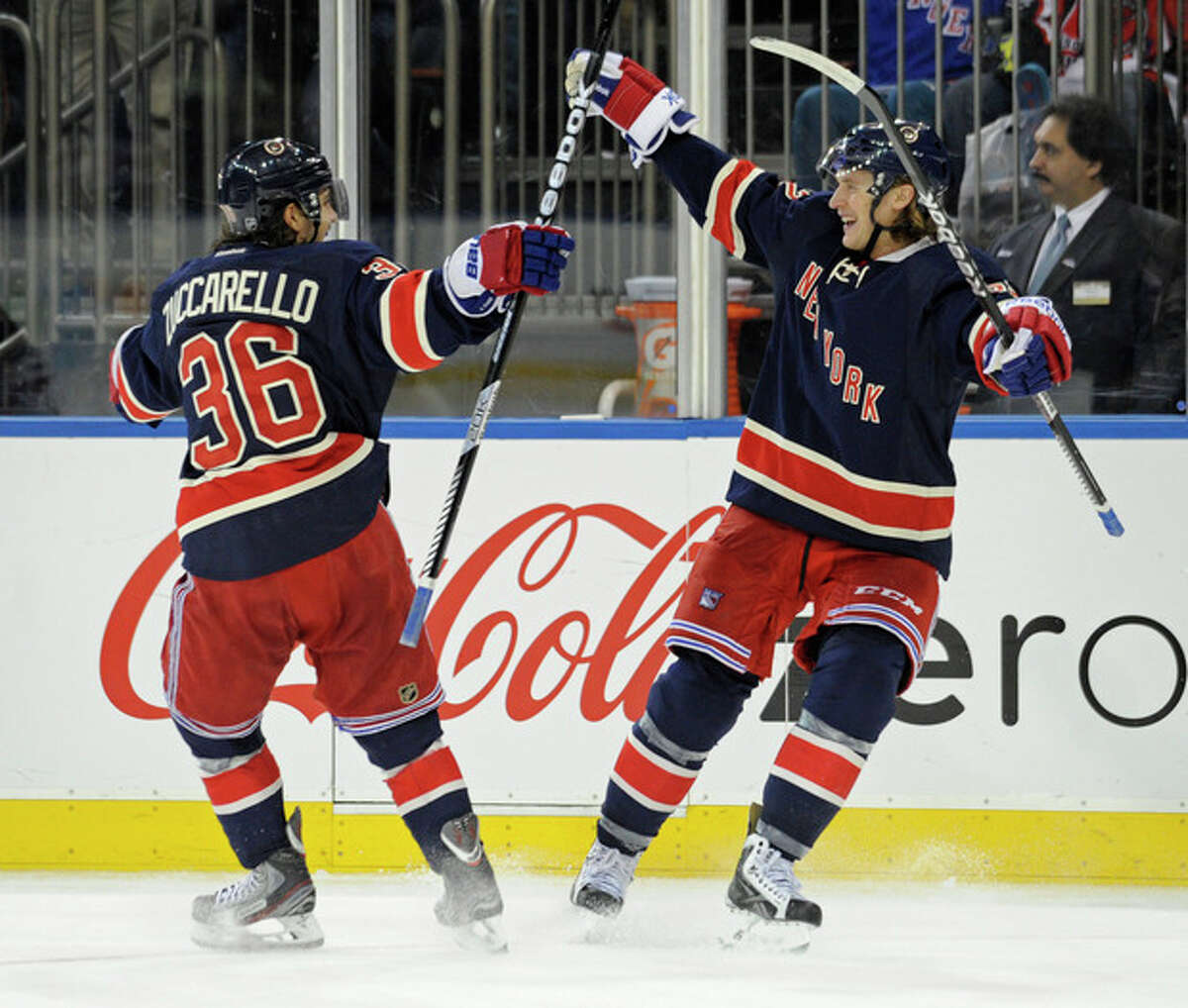 New York Rangers' Carl Hagelin, right, celebrates his goal with Mats Zuccarello during the second period of an NHL hockey game against the Carolina Hurricanes on Saturday, Nov. 2, 2013, at Madison Square Garden in New York. (AP Photo/Bill Kostroun)
