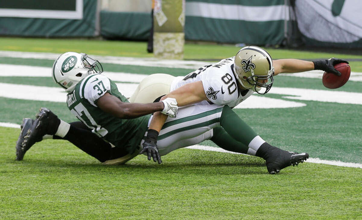 New Orleans Saints tight end Jimmy Graham (80) dives forward for a touchdown as New York Jets free safety Jaiquawn Jarrett (37) attempts to stop him during the first half of an NFL football game Sunday, Nov. 3, 2013, in East Rutherford, N.J. (AP Photo/Mel Evans)