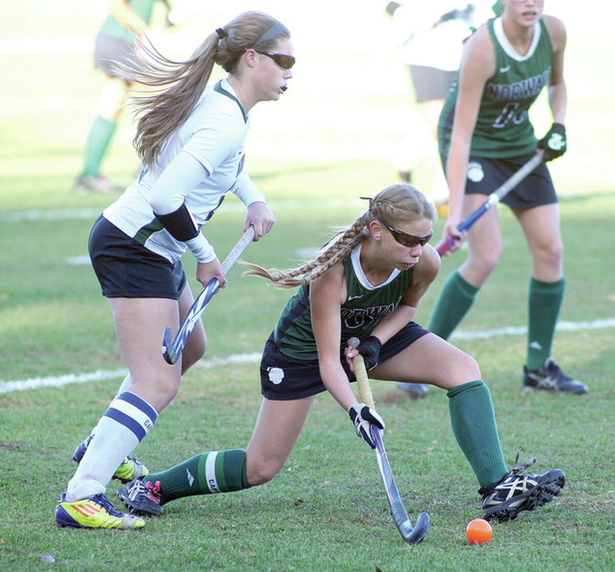 Hour photo/John Nash Norwalk's Greta McConnell, bottom, gets ready to push the ball up the field as New Milford's Corinne Heymach trails during Monday's Class LL prelim game. New Milford won, 1-0, ending the Bears season.