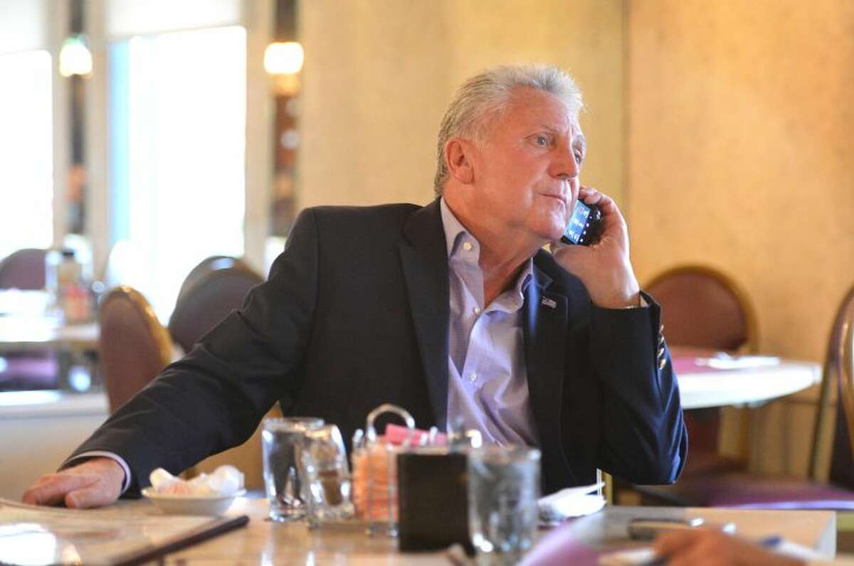 Hour Photo/Alex von Kleydorff . Mayor Elect Harry Rilling takes a phone call while talking to The Hour at Penny's diner, the day after being elected.