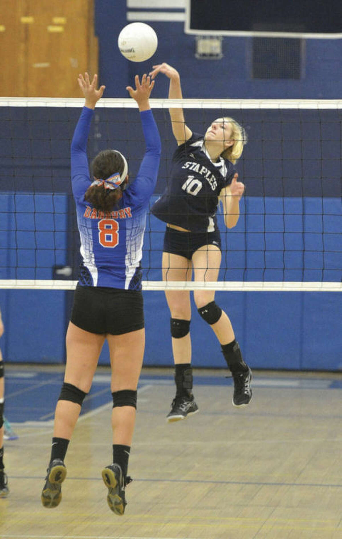 Amelia Brackett of Staples, right, goes up for a kill during Thursday's girls volleyball state tournament match against Danbury. Brackett had 22 kills in the second-seeded Wreckers' 3-1 win. Hour Photo/ Alex von Kleydorff