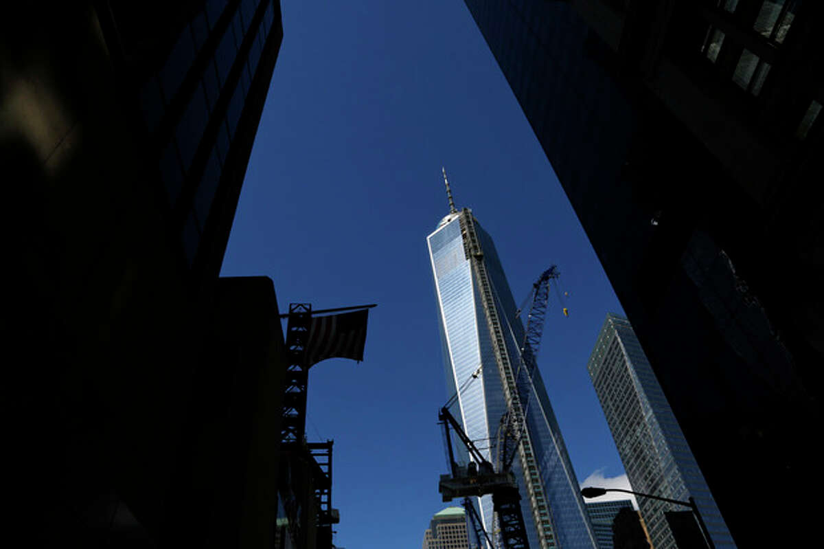 FILE - This Sept. 22, 2013 file photo shows a partial view of One World Trade Center, a skyscraper built at the site of the 9/11 attacks on the World Trade Center in New York. Soaring above the city at 1,776 feet, 104-story One World Trade Center is in contention with Chicago's Willis Tower for the title of America's tallest building. A committee of architects recognized as the arbiters on world building heights is meeting Friday Nov. 8, 2013 in Chicago to decide whether a design change affecting One World Trade Center's needle disqualifies its hundreds of feet from being counted, which would deny the building the title of nations tallest giving the title to the 110 story Willis Tower at 1,450 feet. (AP Photo/Lefteris Pitarakis)
