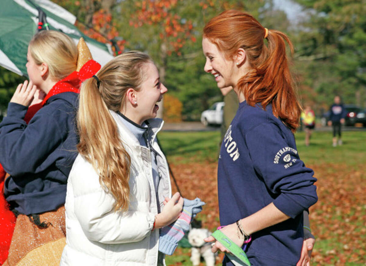 Lizzy Nielsen and Charlotte Galef greet each other at the annual Turkey Trot to benefit The Open Door Norwalk Emergency Shelter at Irwin Park in New Canaan Sunday morning. Hour Photo / Danielle Robinson