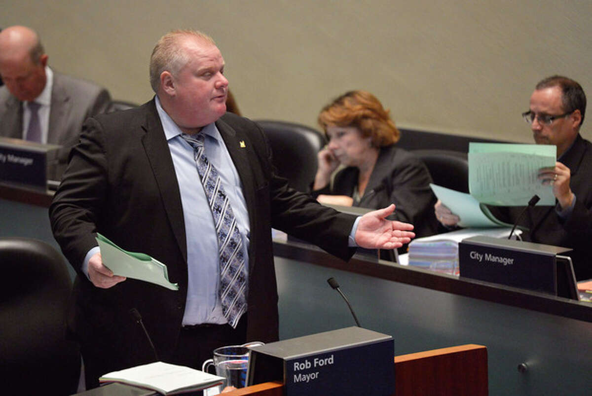Mayor Rob Ford speaks at city council in Toronto on Wednesday, Nov. 13, 2013. Almost every member of Toronto's City Council stood up and asked Mayor Rob Ford to take a leave of absence during a city council meeting Wednesday after he admitted smoking crack last week."Together we stand to ask you to step aside and take a leave of absence," Councilor Jaye Robinson said, reading open letter to Ford in City Council. The council voted 41-2 to accept the letter Wednesday, with the embattled mayor casting one of the opposing votes. (AP Photo/The Canadian Press, Nathan Denette)