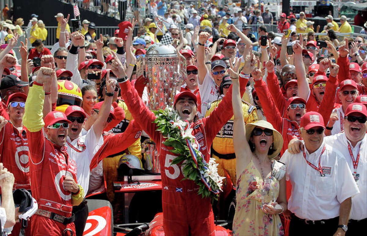 FILE- In this May 27, 2012, file photo, IndyCar driver Dario Franchitti, center, of Scotland, celebrates with his crew after winning the Indianapolis 500 auto race at the Indianapolis Motor Speedway in Indianapolis. The three-time Indianapolis 500 winner said Thursday, Nov. 14, 2013, that doctors have told him he can no longer race because of injuries sustained in an IndyCar crash last month. He fractured his spine, broke his right ankle and suffered a concussion in the Oct. 6 crash at Houston. (AP Photo/Darron Cummings, File)
