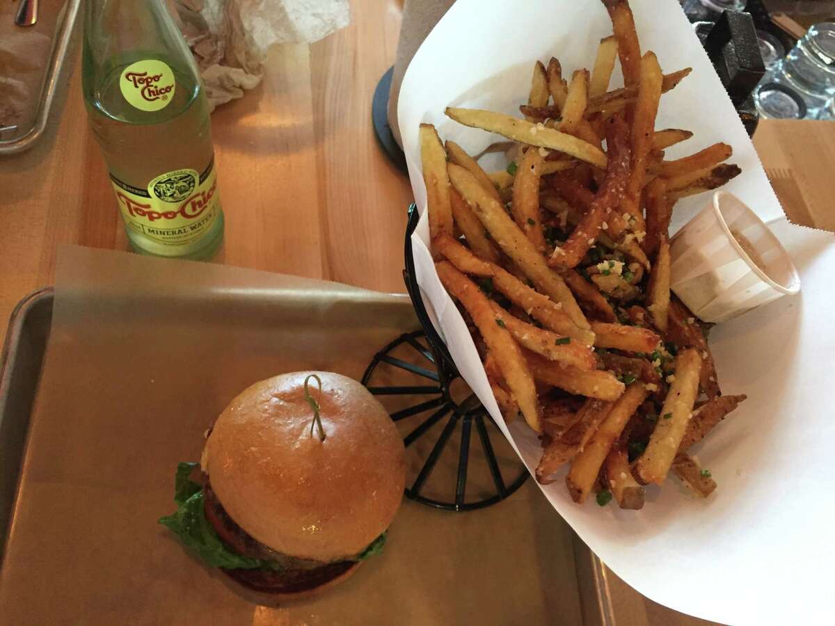 Goodnight / Good Cause burger with fries and Topo Chico at Hopdoddy Burger Bar.
