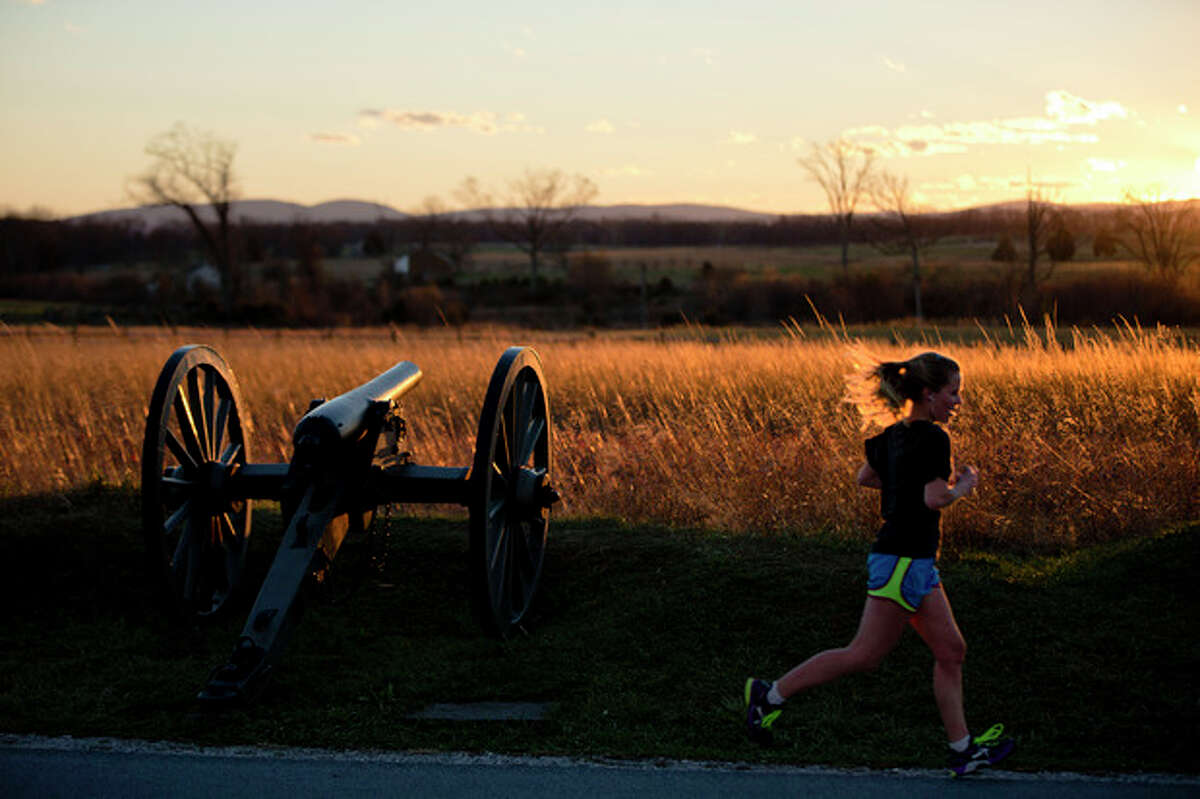 A runner passes through Gettysburg National Military Park, Monday, Nov. 18, 2013, in Gettysburg, Pa. Nov. 19th marks the 150th anniversary of President Abraham Lincoln's short speech that has gone on to symbolize his presidency and explain the sacrifices made by Union and Confederate forces during the U.S. Civil War. (AP Photo/Matt Rourke)