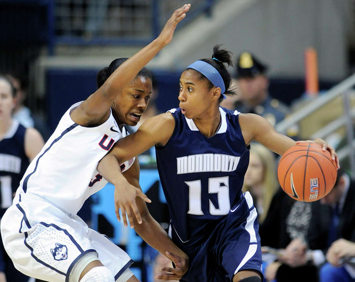 Connecticut's Brianna Banks (13) guards Monmouth's Jasmine Walker during the first half of an NCAA college basketball game, in Storrs, Conn., on Saturday, Nov. 23, 2013. (AP Photo/Fred Beckham)