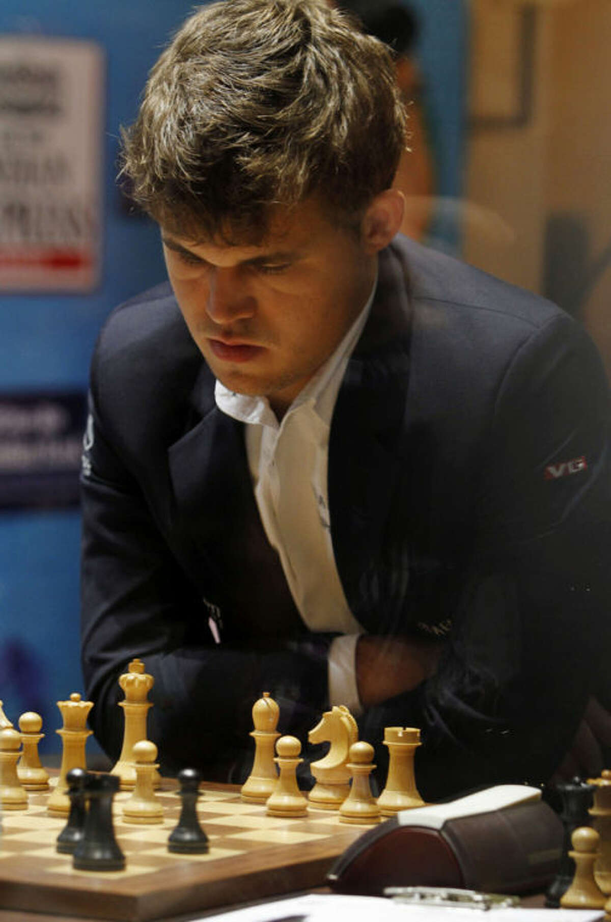 Norway?’s Magnus Carlsen plays against reigning world chess champion India?’s Viswanathan Anand during the Chess World Championship match in Chennai, India, Friday, Nov. 22, 2013. (AP Photo/Arun Sankar K.)