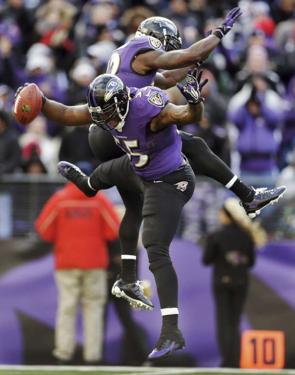 Baltimore Ravens outside linebacker Terrell Suggs (55) celebrates his fumble recovery with teammate strong safety James Ihedigbo during the first half of an NFL football game against the New York Jets in Baltimore, Md., Sunday, Nov. 24, 2013. (AP Photo/Patrick Semansky)